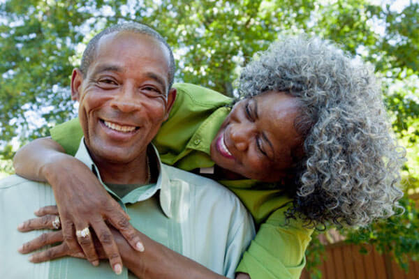 Older African American couple embrassing