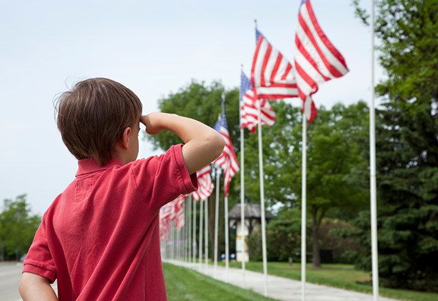 kid saluting to the US flag