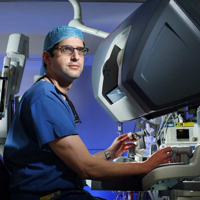 Ardavan Akhavan in front of surgery equipment
