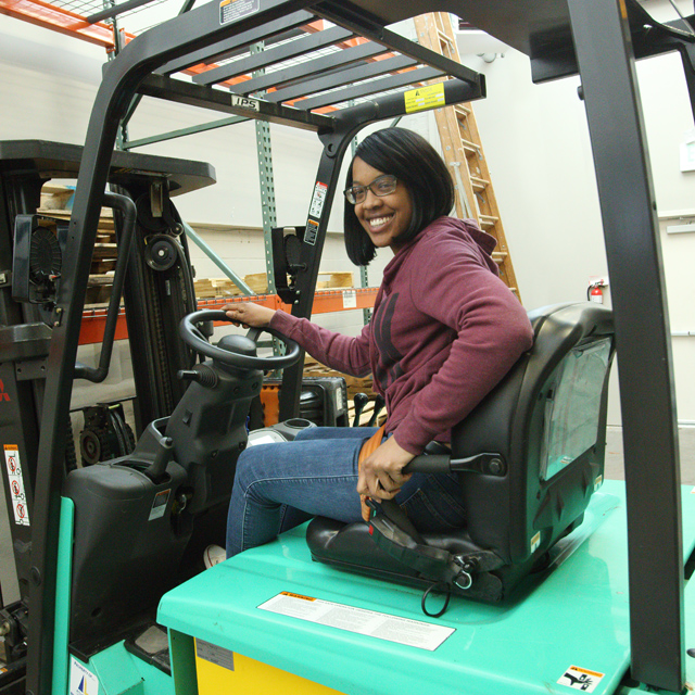 The photo shows Jasmine Montgomery on a forklift. 