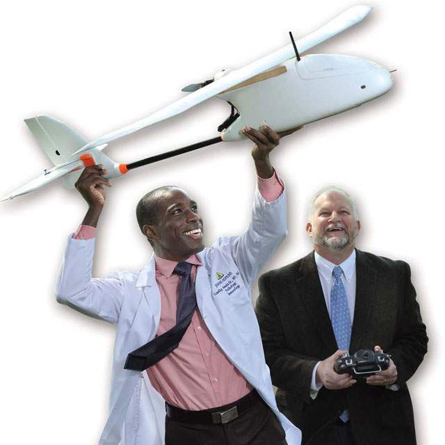 Dr. Timothy Amukele launches a drone with Robert Chalmers from the AppliedPhysics Laboratory