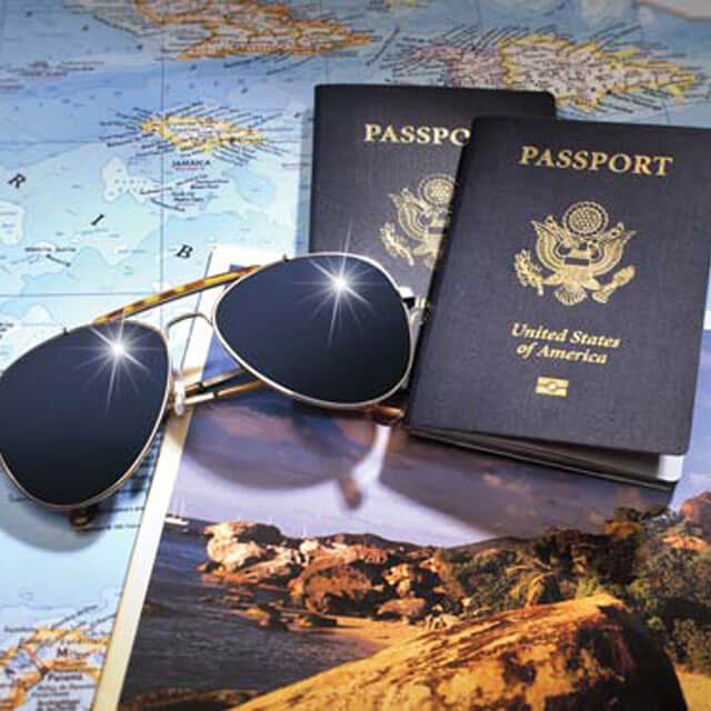 Sunglasses and passports laid out across a world map
