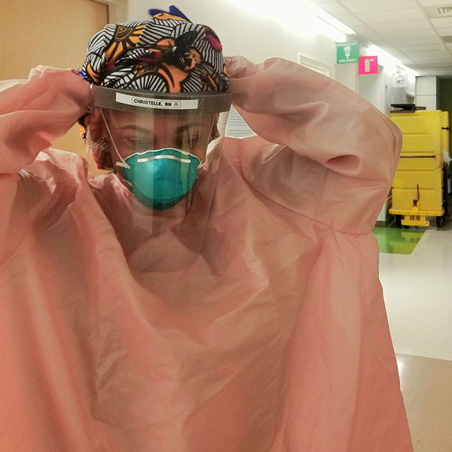Christelle Asu puts on a face mask, shield and gown before treating COVID-19 patients. 