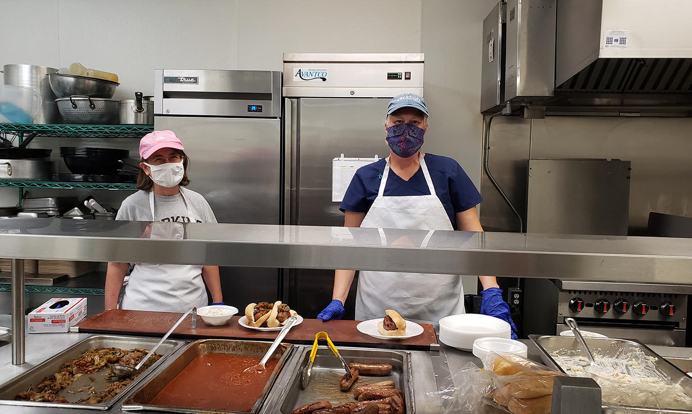 From left, scientists Karen D'Agostino and Carrie Holdren-Serrell serve food at Helping Up Mission
