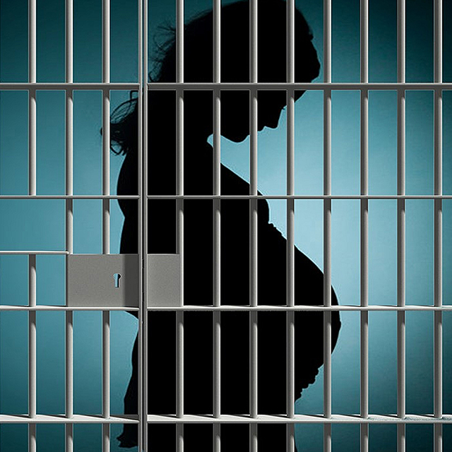 An illustration shows a silhouette of a pregnant woman in a jail cell 