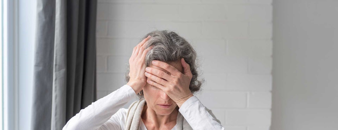 Older woman holding face in pain