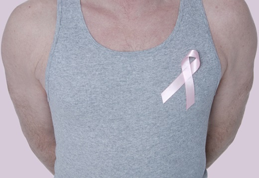 man in t-shirt wearing a pink ribbon