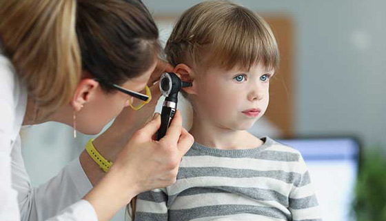 Young child having their ear examined for an ear infection
