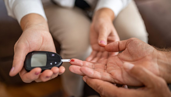 Doctor checking patients blood sugar