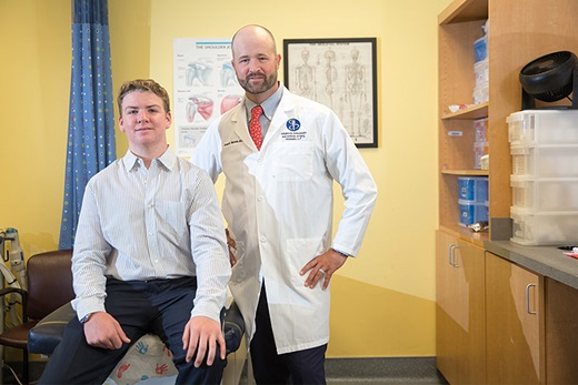 Christopher with expert in orthopaedics, Drew Warnick, M.D. of John Hopkins All Children's Hospital. 