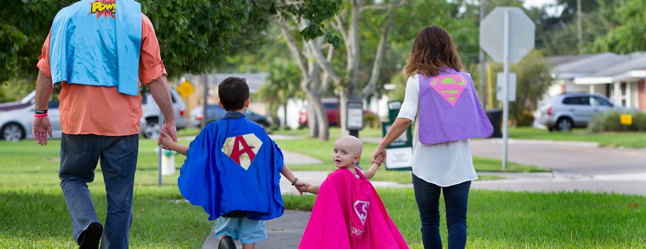 Sofia and her family in their super hero capes
