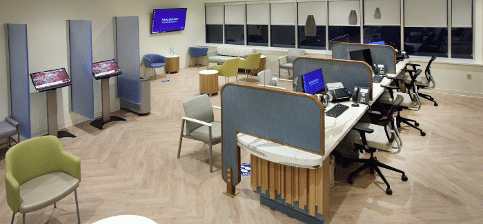 side angle view of reception desk where there are dividers separating the receptionists 