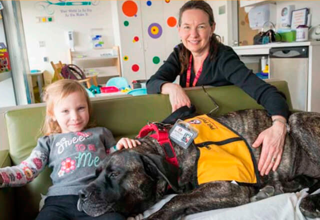 volunteer with child and service dog