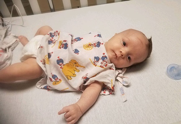 Julian in a hospital crib