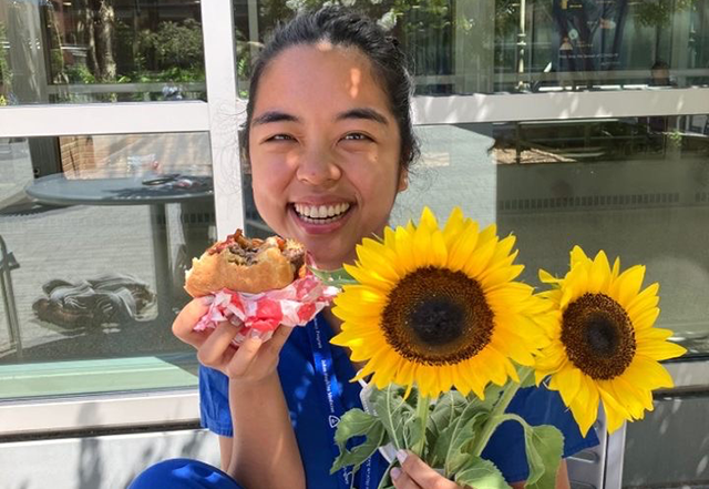 Resident enjoys a burger and sunflowers