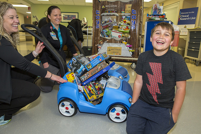 Patient Sebastian bringing toys he received for his birthday to donate to the children at Johns Hopkins All Children's Hospital