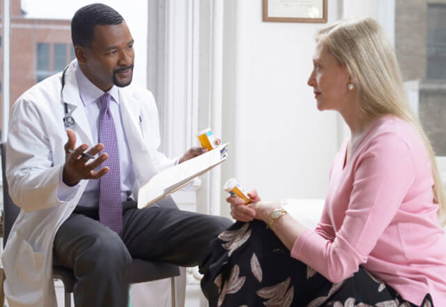 Suburban doctor discusses care with behavioral health patient
