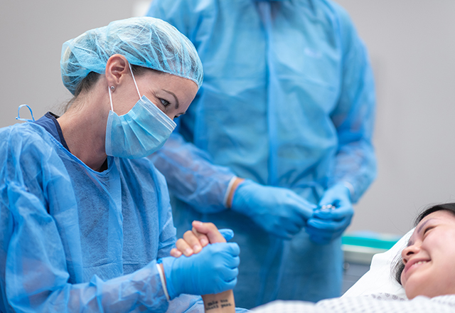 johns hopkins surgery - surgeon holding woman's hand before surgery