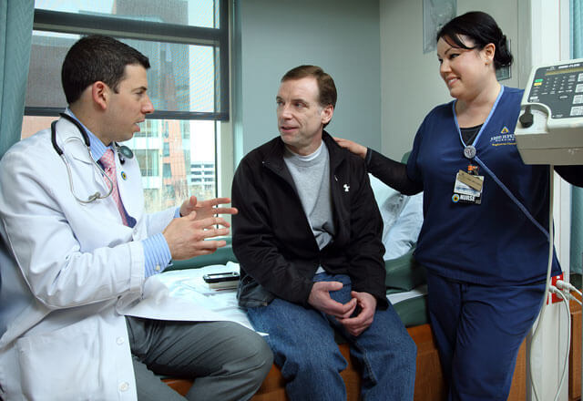 johns hopkins surgery - doctor and nurse talking to patient in exam room