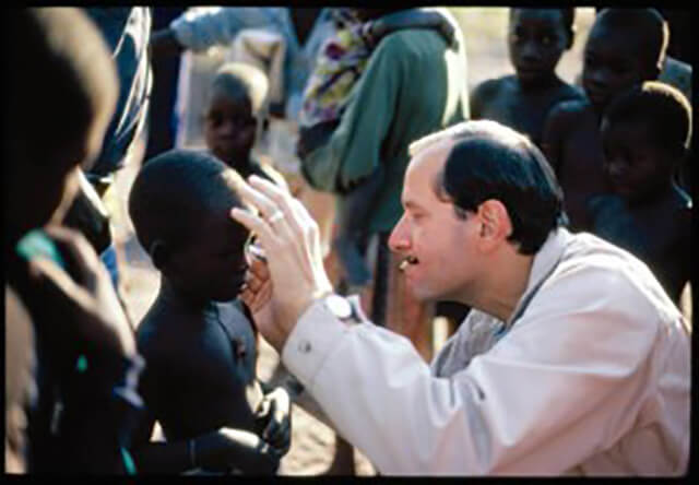 Alfred Sommer observes a patient in Africa
