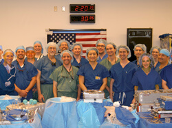 A TRIUMPH OF TEAMWORK: Surgeons who participated in the double arm transplant gather in the operating room shortly after the historic surgery. W.P. Andrew Lee, center, director of the team, is flanked by surgeons from Johns Hopkins, the Curtis National Ha