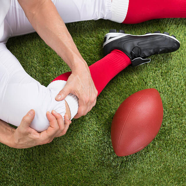 Football player with a knee injury.