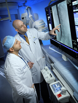 Anobel Tamrazi, left, and Mark Lessne are using laser sheath tissue ablation to remove IVC filters, like the one pictured here, that have become trapped in the blood vessel.