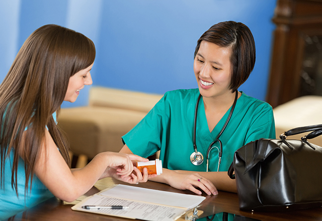 woman checking medication with nurse