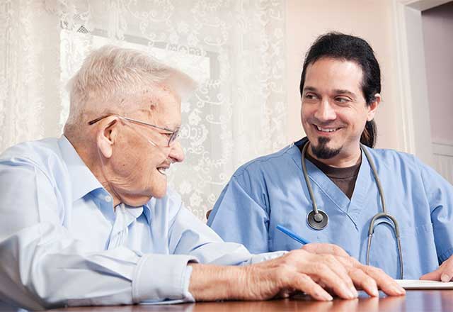 Healthcare provider working with a geriatric patient.