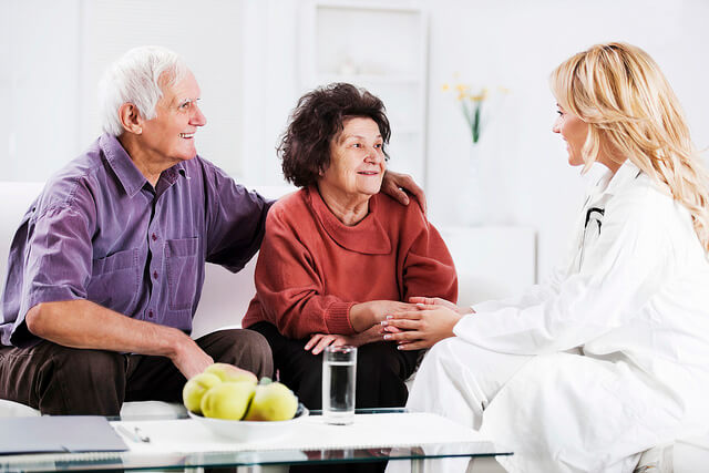 Doctor speaking to patient and caregiver