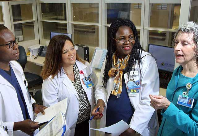 Nurses and educators talking in the hospital hallway