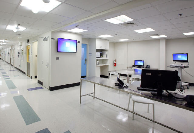 The hallway of the BCU with monitors and screens mounted on the walls.