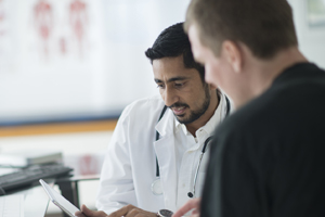 A physician speaking with a patient