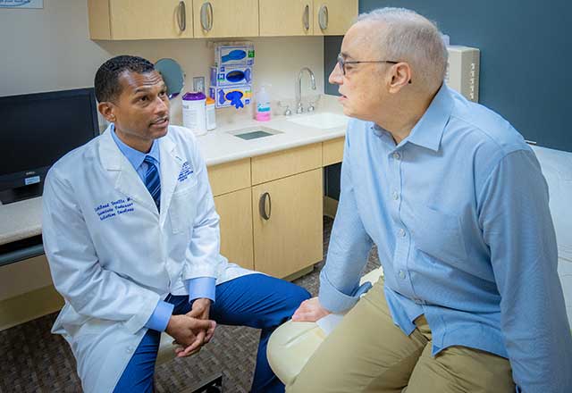 Dr. Deville speaking with a patient
