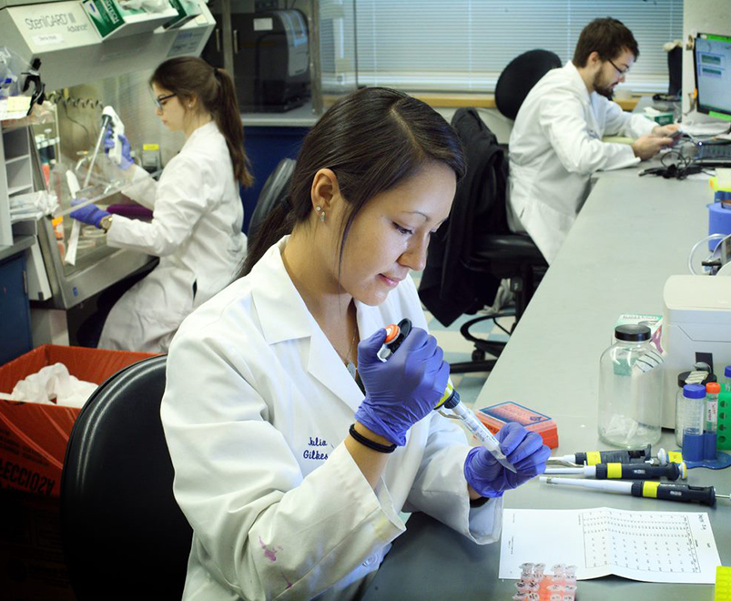 researcher in lab uses pipette