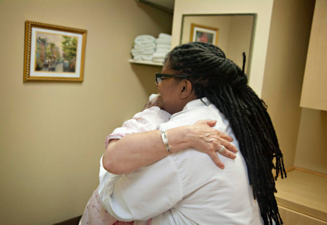 practitioner hugs patient