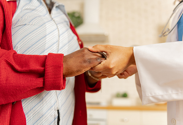 doctor holds patients hands