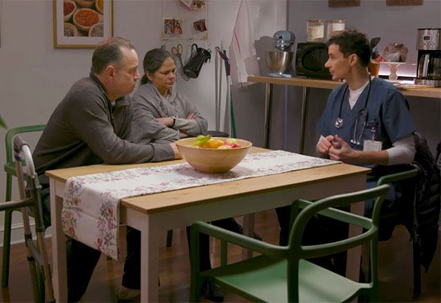Screengrab from one of the telenovela videos, showing the two family members and caregiver.