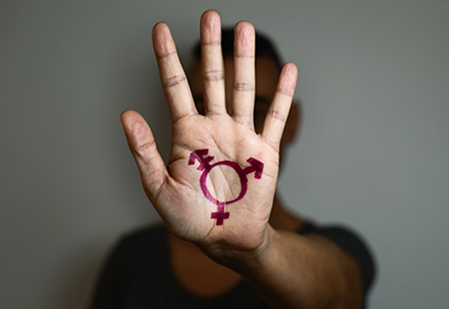 Hand with gender symbols.