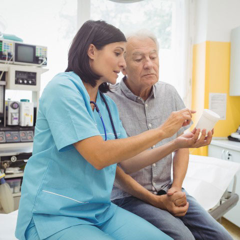 Physician speaking with patient in care room