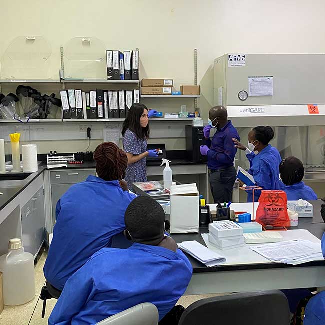 Laura working with a team of professionals in the lab
