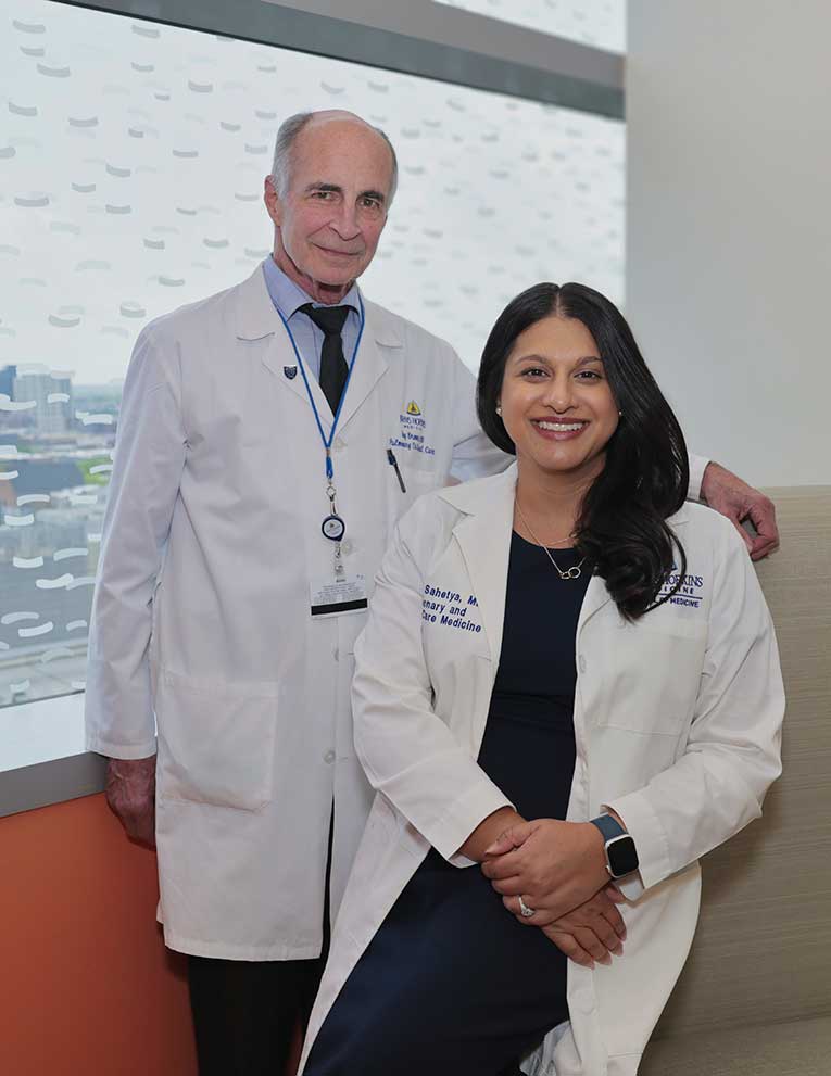 Dr. Sahetya and Dr. Brower in white coats smiling together