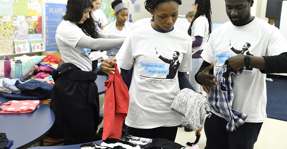 Volunteers sort through clothing donations.