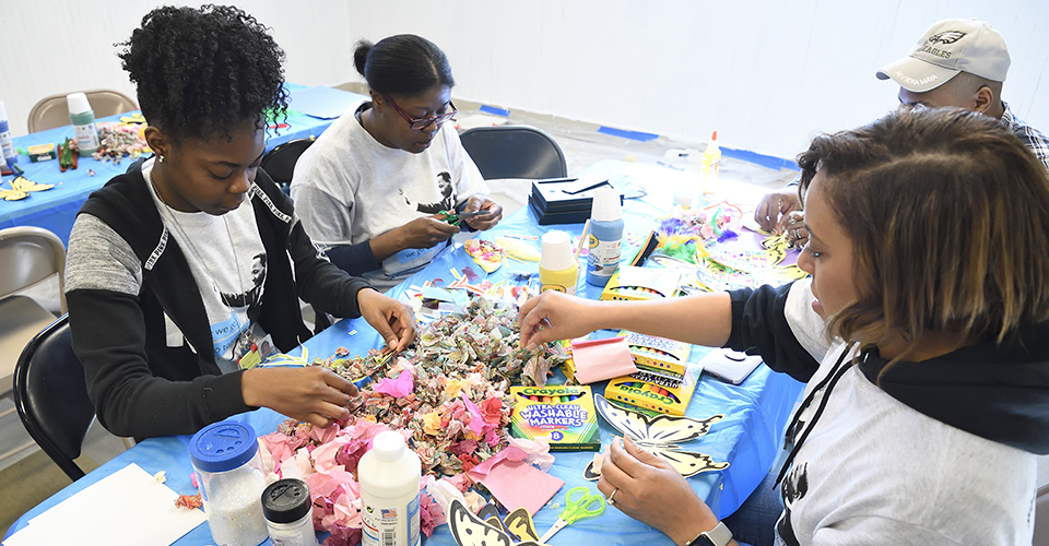 A group of people make crafts together.