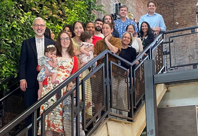 ID fellows and faculty posing on a staircase