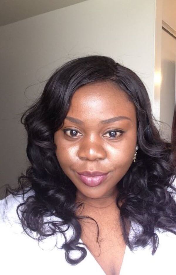 Photo of Abi Kuforiji. She has long hair and is wearing a white shirt