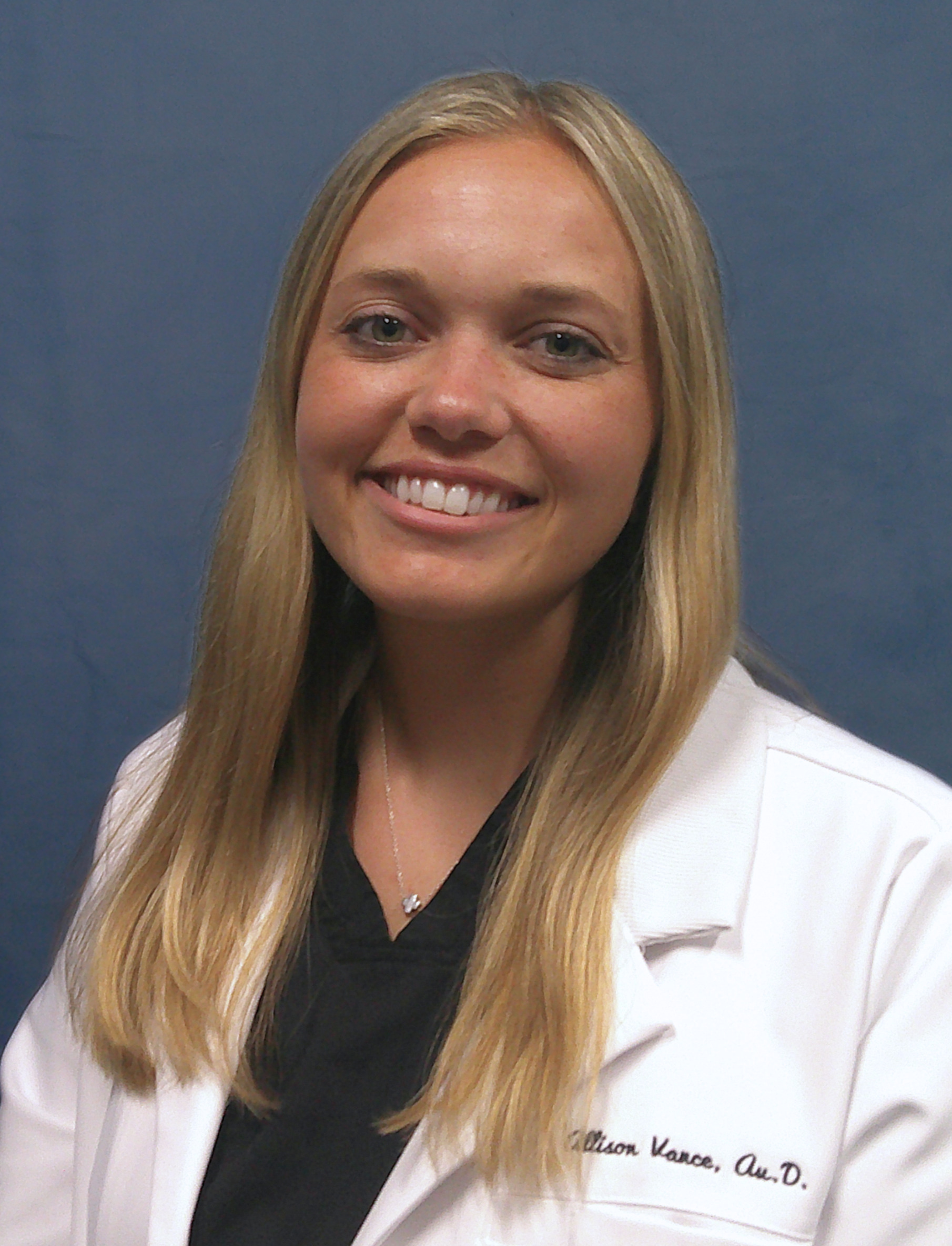 Allison Vance head shot in front of gray-blue background