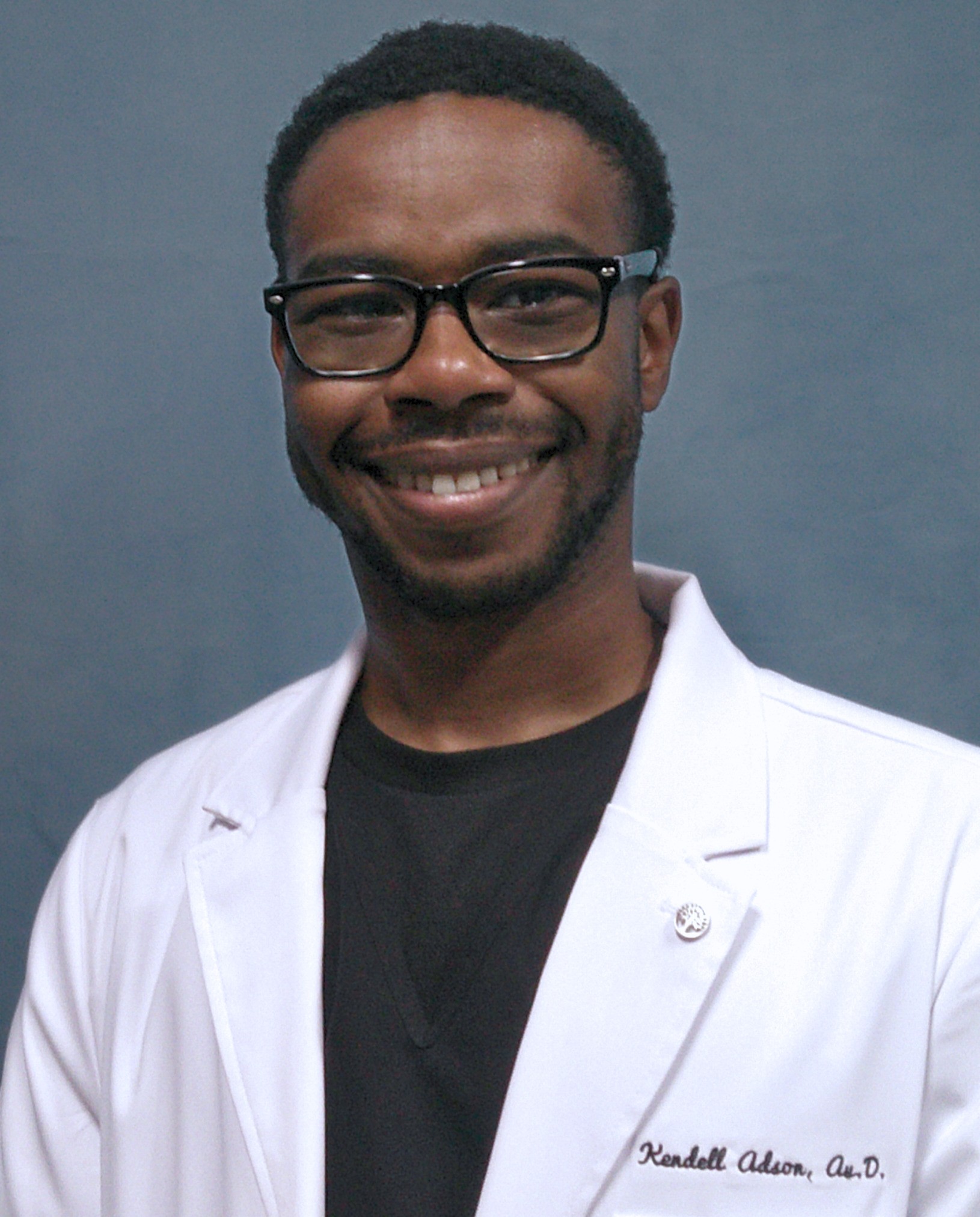 Kendell Adson head shot in front of gray-blue background