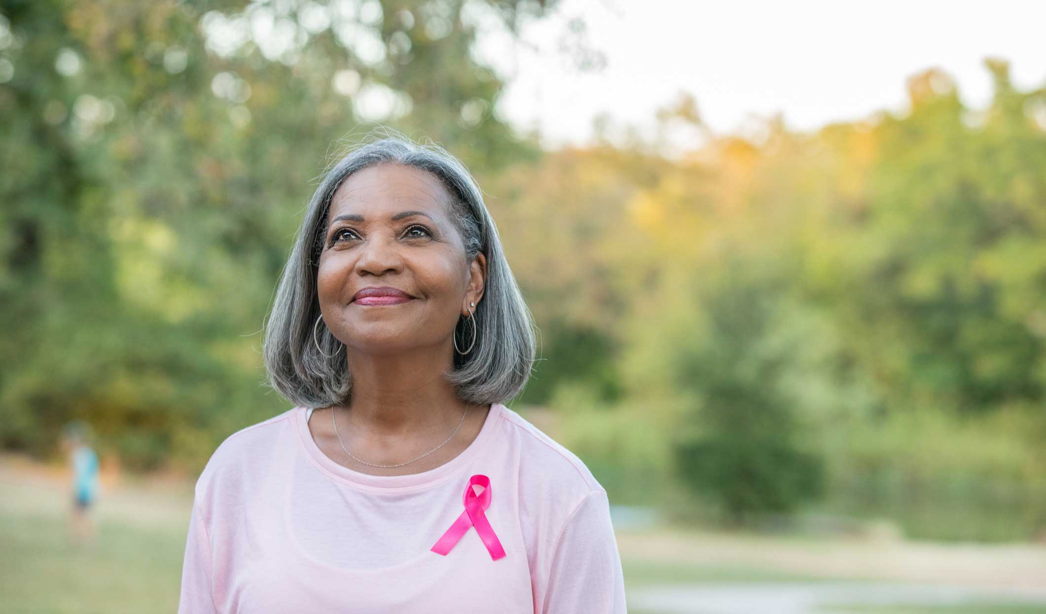 Senior woman with breast cancer ribbon