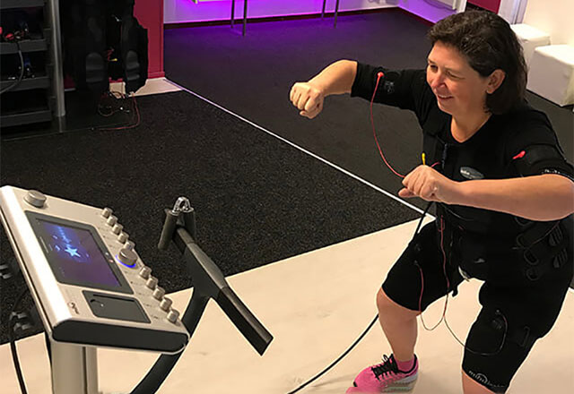 Vivienne using a machine while exercising.
